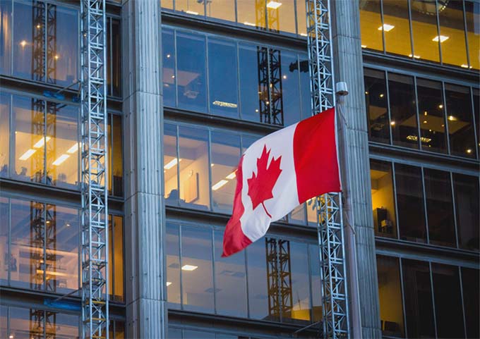 A Canadian flag flying in front of a building